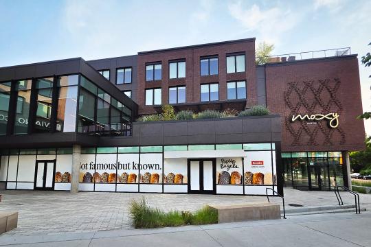 An exterior photo of PopUp Bagels location in the Moxy Hotel